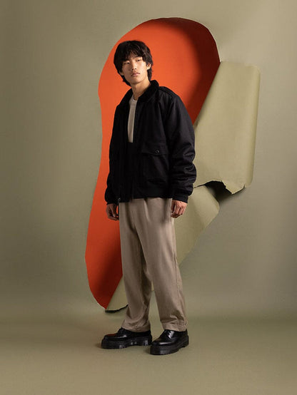 Side-view of a person wearing an  1940s B-10 Bomber Jacket by Alpha Industries.