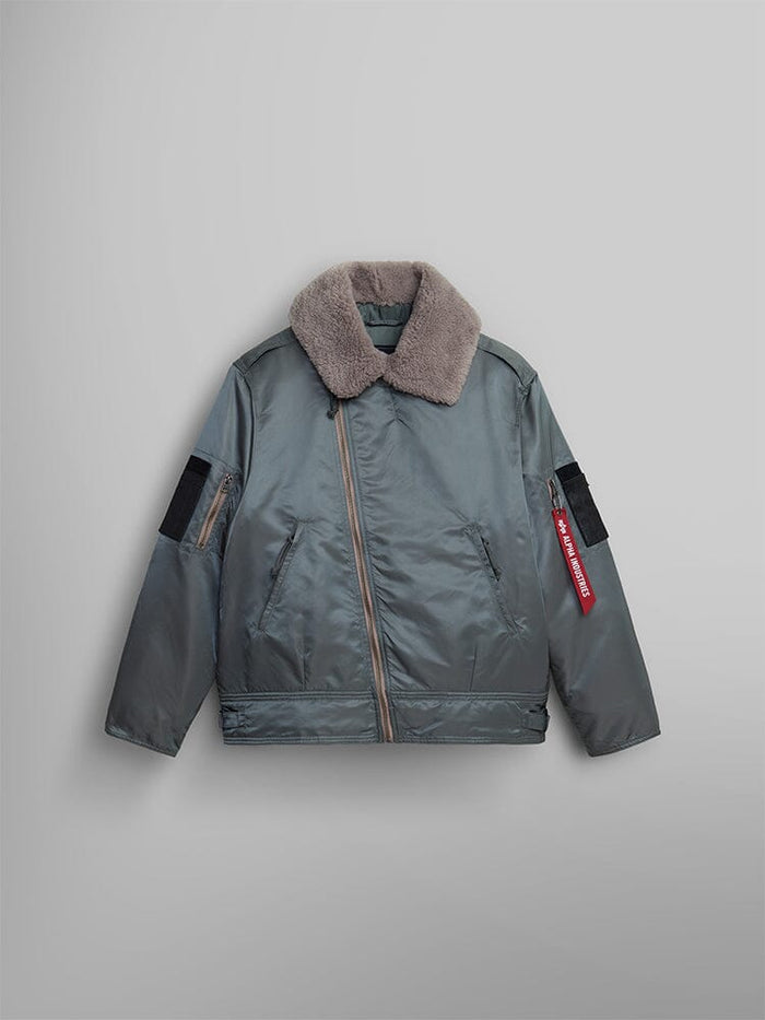 The 1960s RCAF Canadian Airforce Type III Jacket in Field gray by Alpha Industries with a shearling collar and zipper front. This piece includes utility pockets, an adjustable waistband, and a red tag on the left sleeve.