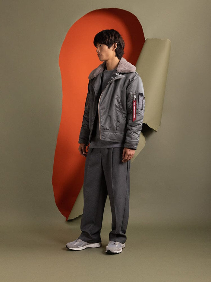 Side view of a person wearing the 1960s RCAF Canadian Airforce Type III Jacket in field gray by Alpha Industries.