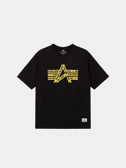 Alpha Caution Tape Tee by Alpha Industries is a black short-sleeve shirt with yellow graphic and diagonal Alpha Industries text on front.