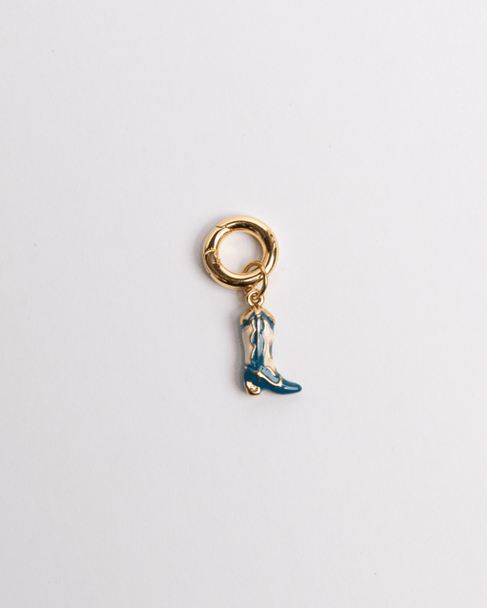 A blue boot charm with a gold-colored clasp and detailing on a white background.