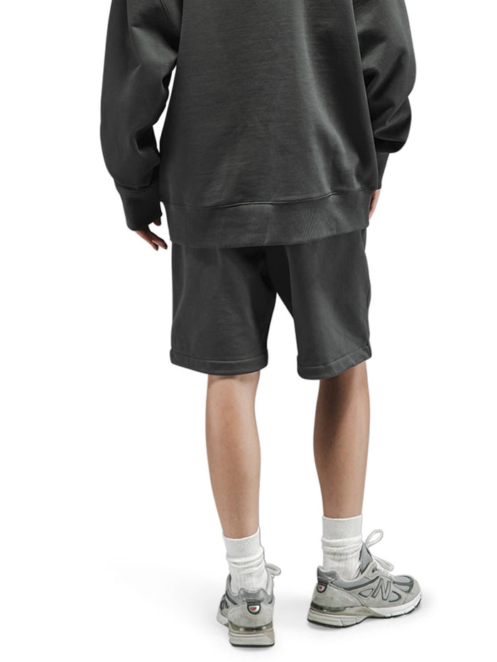 Alpha Industries Essential French Terry Short in dark color, featuring elastic waistband and side pockets.