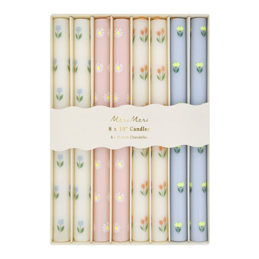 Set of 8 floral-patterned candles in pastel colors with 'Mireille Mermel' branding.