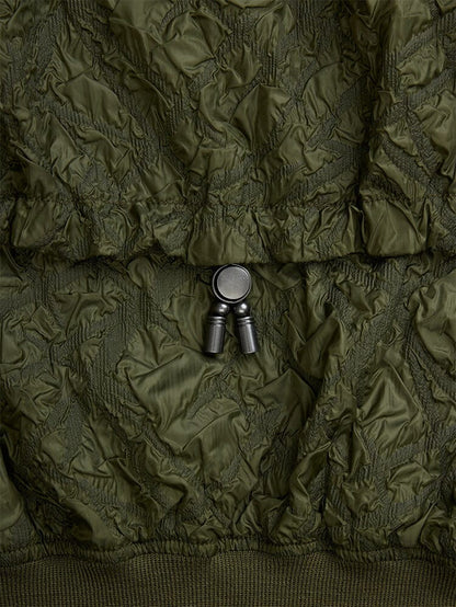 Alpha Industries L-2B Bubble Flight Jacket, olive green outer shell with black plastic adjustable cord lock.