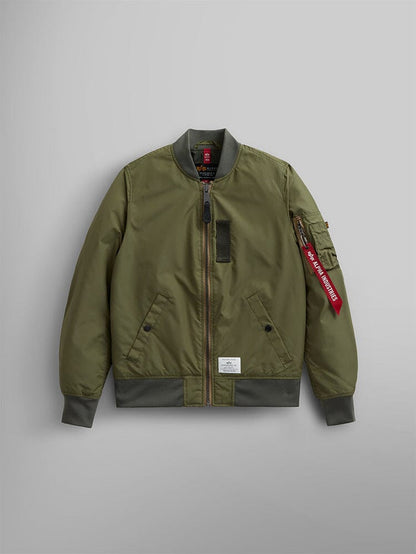 The L-2B Skymaster Gen II Bomber Jacket W by Alpha Industries is designed in OG-107 green and crafted from lightweight, water-resistant nylon. It features ribbed cuffs, hem, and collar, a zippered front closure, side pockets, and includes a stylish red oxygen tab detail on the sleeve.