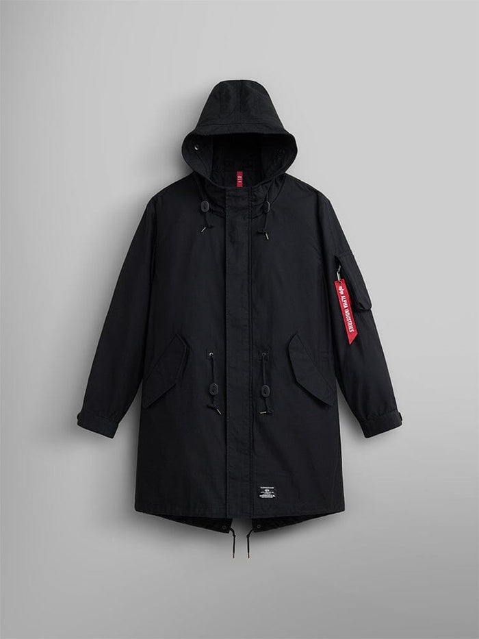 Alpha Industries M-59 Fishtail Mod Parka in Black with front flap pockets, moldable wire hood, drawstring details, and red Remove Before Flight tag on left sleeve.