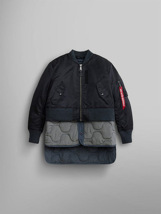 The Women's 3-in-1 MA-1 Quilted Liner by Alpha Industries, in black, is featured over an onion-quilted grey coat with button details, highlighting its versatile 3-in-1 style.