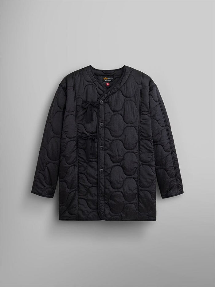 Women's Mixed Media Quilted Long Liner by Alpha Industries showcases a black hue with onion quilting that adds texture and a nylon liner for supreme comfort.