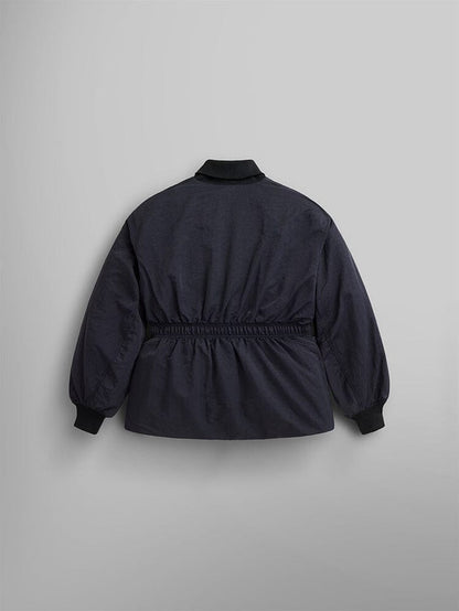 The Women's Short Cinched Waist Jacket by Alpha Industries is a black jacket with a quilted lining and elastic waistband. It features a ribbed collar, cuffs, and hem. The back view showcases an adjustable drawcord waist and welt pocket.