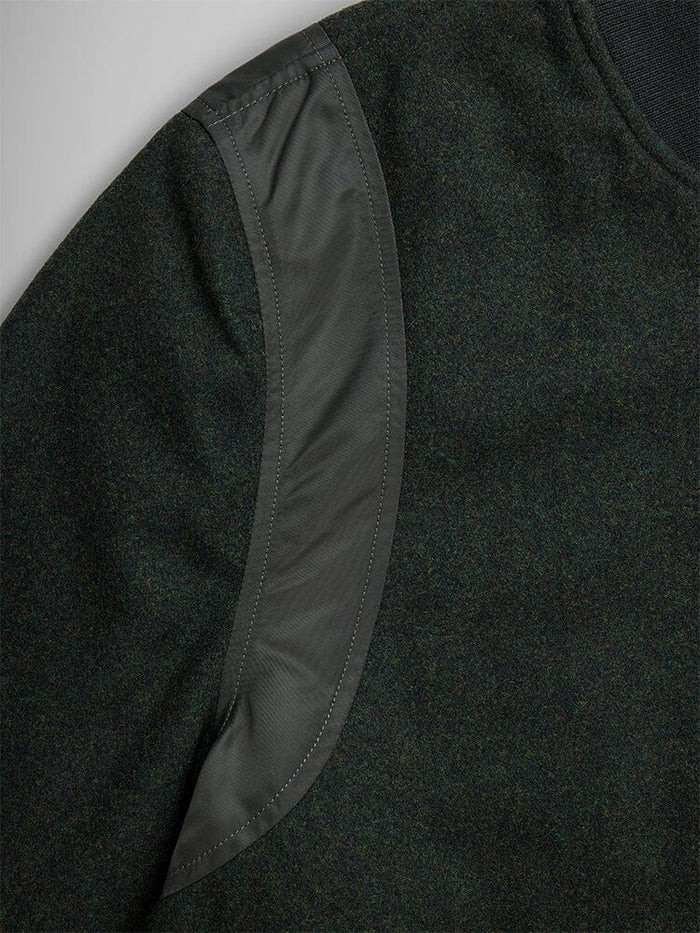 Alpha Industries Wool Varsity Bomber Jacket Gen II, dark green sleeve, curved shiny patch on shoulder, quilted nylon.