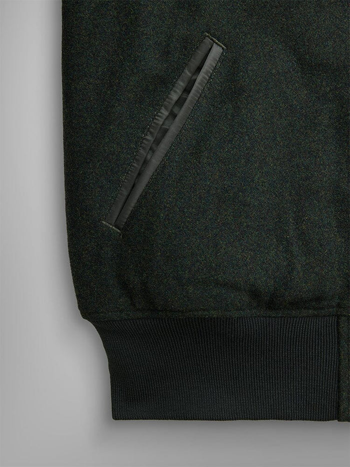 Alpha Industries Wool Varsity Bomber Jacket Gen Ii in dark green, slanted front pocket with leather trim, ribbed hem, nylon quilting.