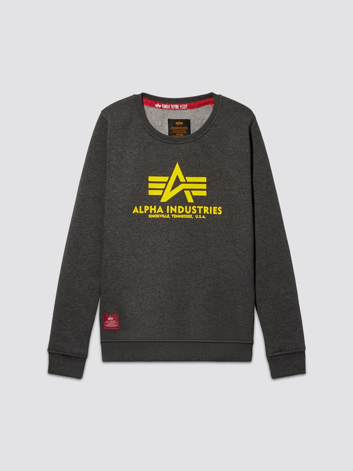 Charcoal heather youth basic sweater featuring a yellow Alpha Industries logo and the text Knoxville, Tennessee, U.S.A. on the front, complemented by a stylish red tag at the bottom hem.